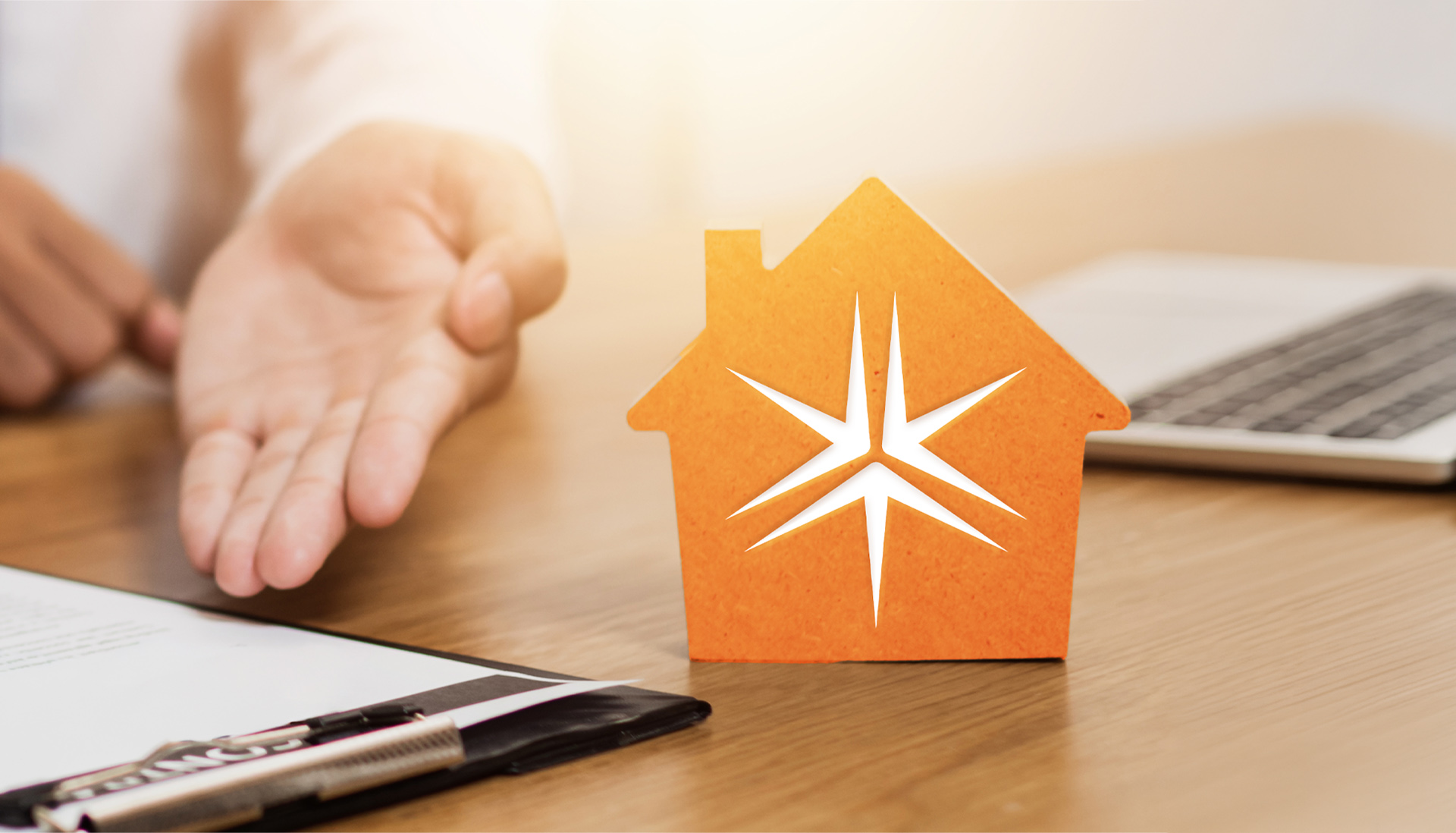 cardboard cutout of an orange house with the Miller Thomson spark