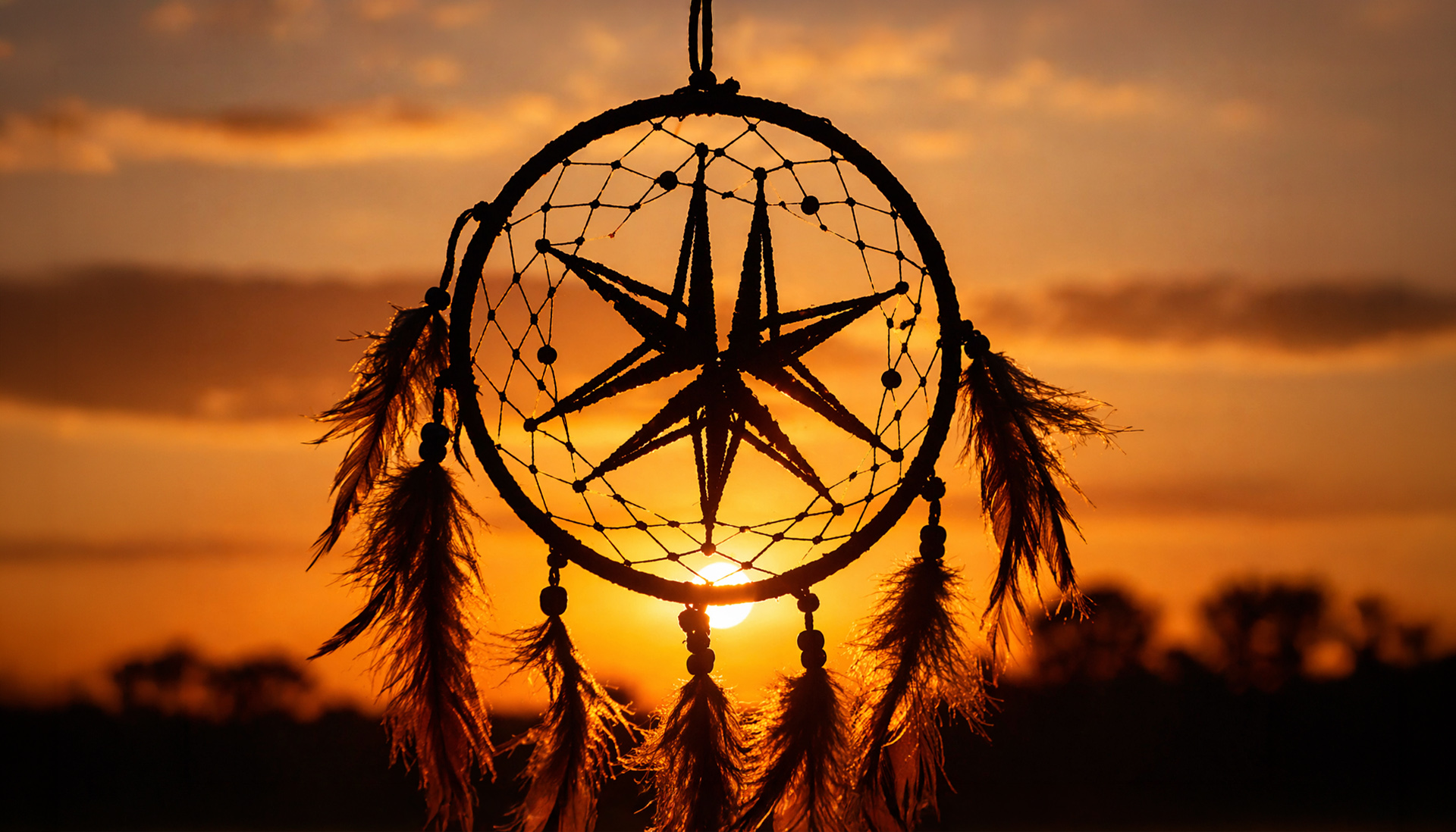 suncatcher with Miller Thomson spark against a orange sunrise in the background