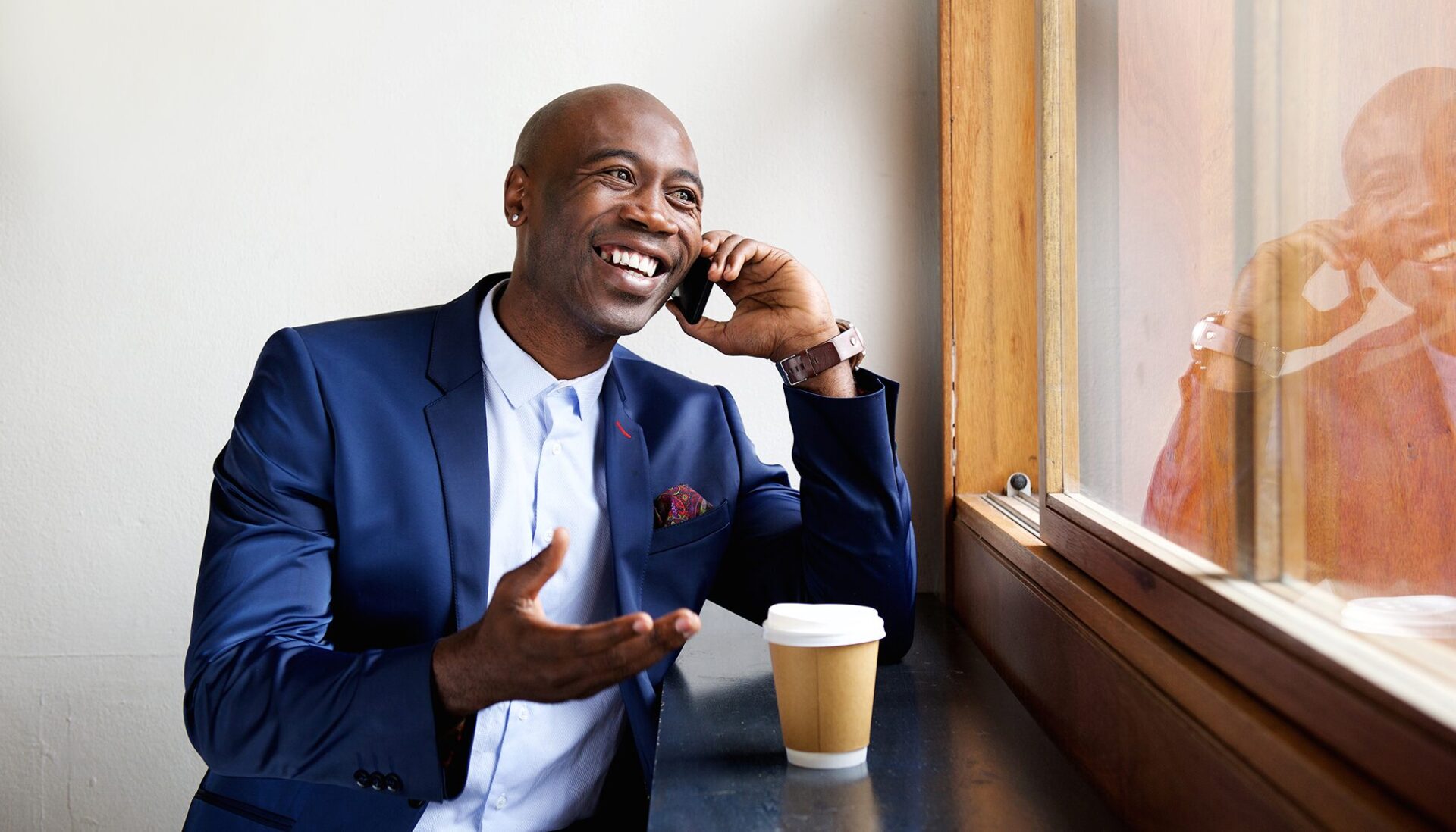 Man in a suit conversing on a mobile phone