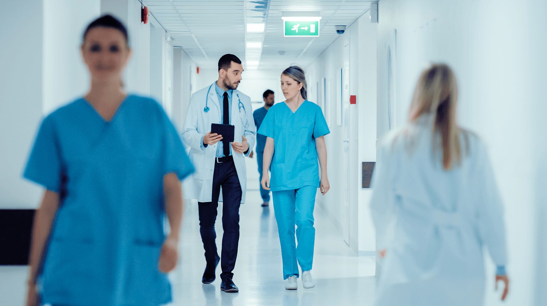 healthcare workers walking down a hospital hallway