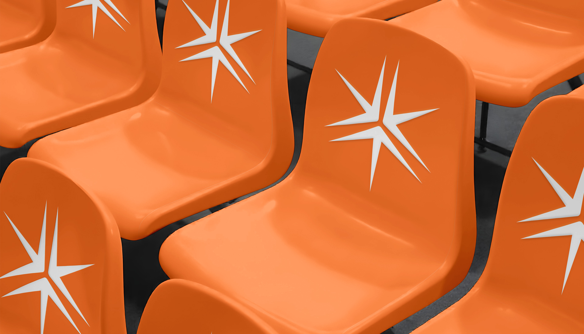Rows of orange stadium chairs with the Miller Thomson spark on the backrest