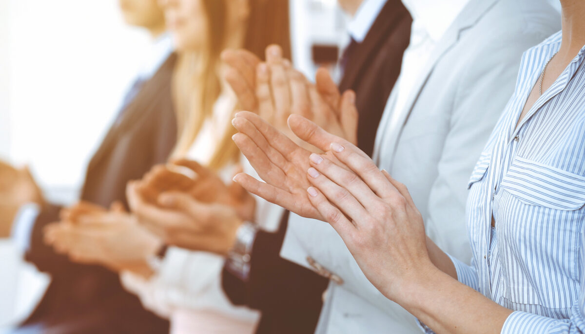 Business people clapping and applause at meeting, close-up of hands.