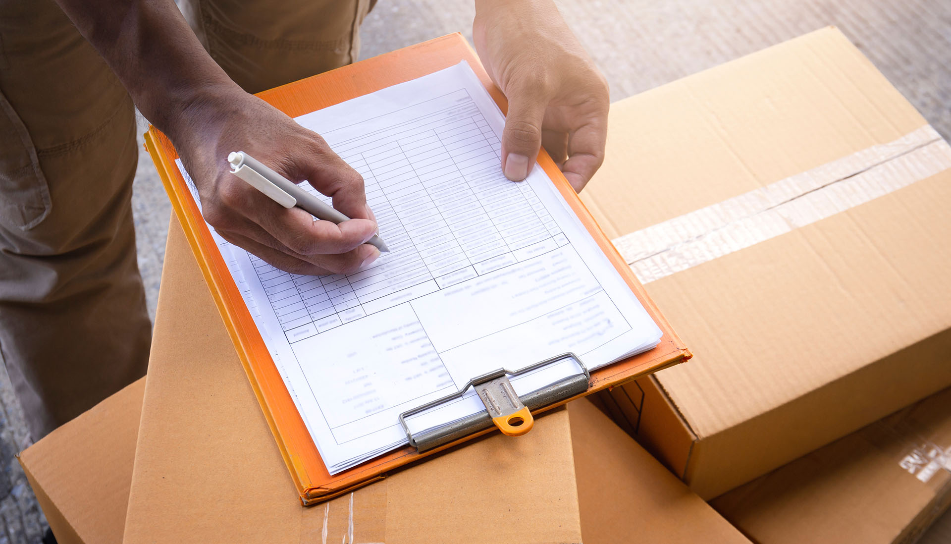 courier driver signing documents on a clipboard
