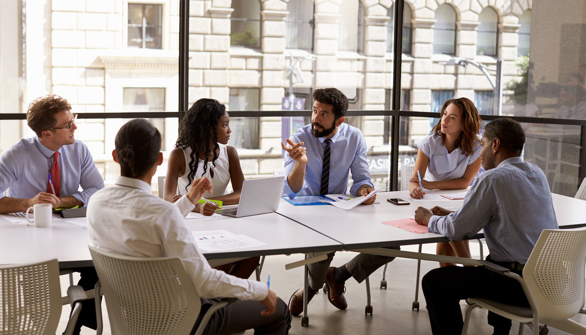 multiethnic business people sitting at a boardroom table