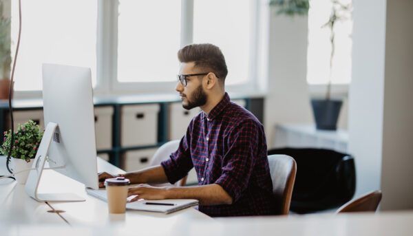 Young accountant working with papers and computer working at office