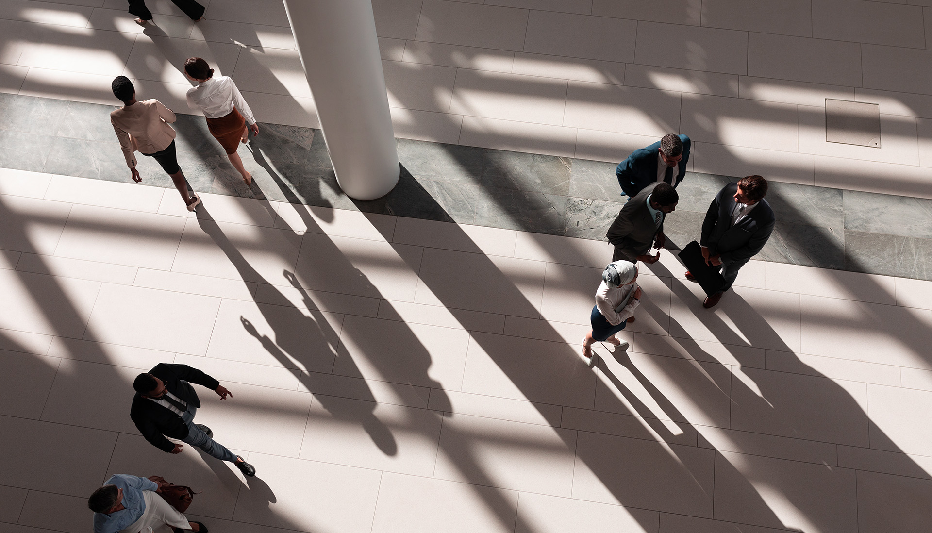 people walking in an office lobby viewed from above