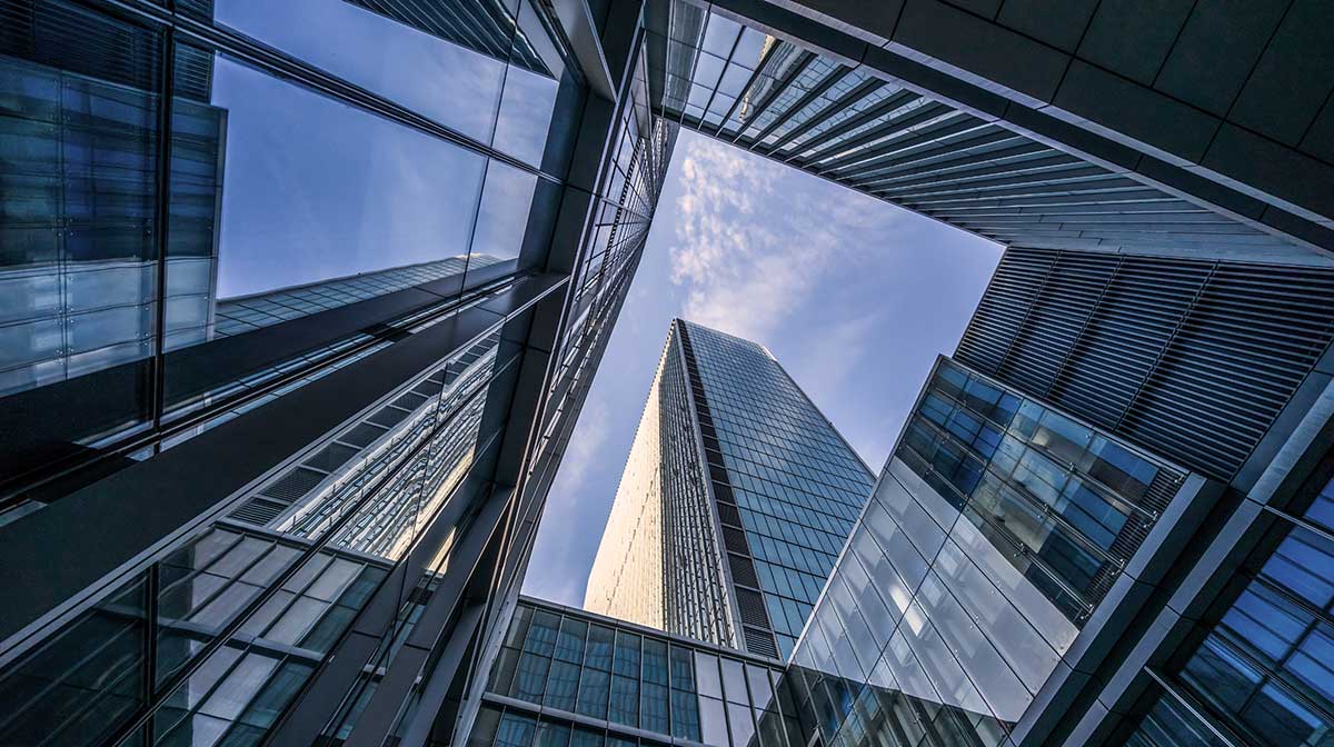 Office buildings - with reflections of office buildings in the windows.