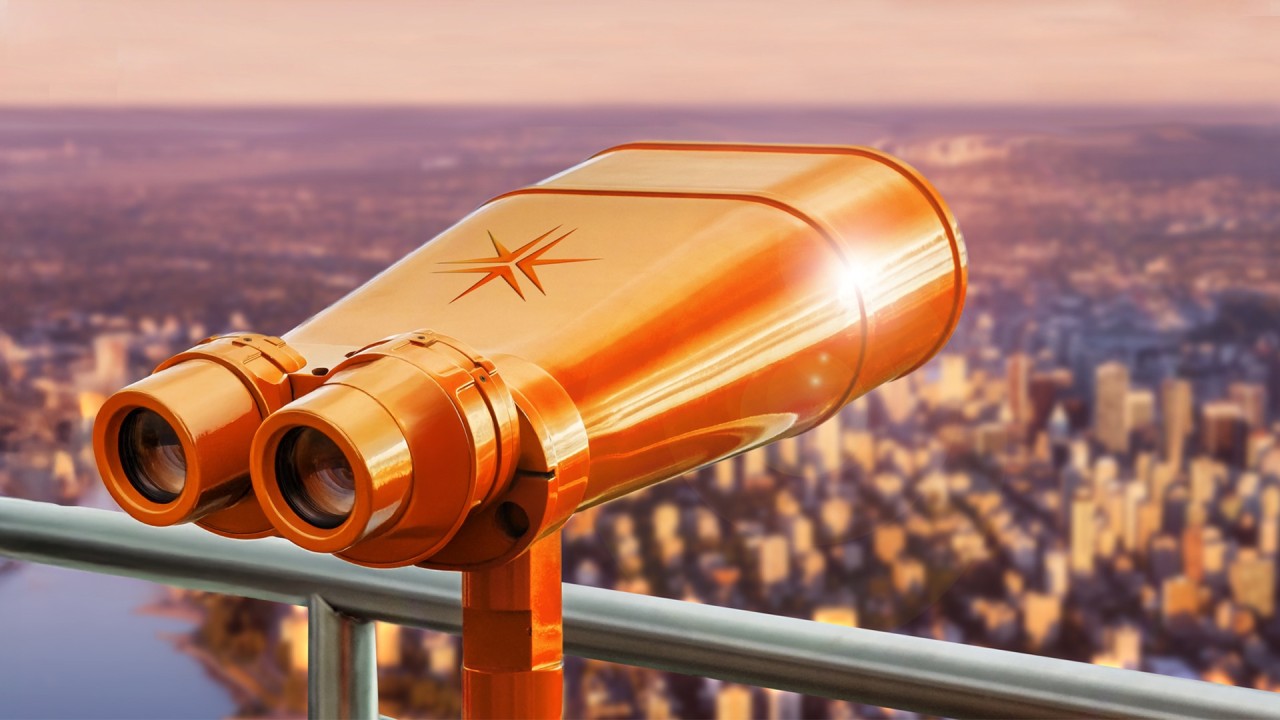 orange binoculars with miller thomson spark on a balcony looking over a city