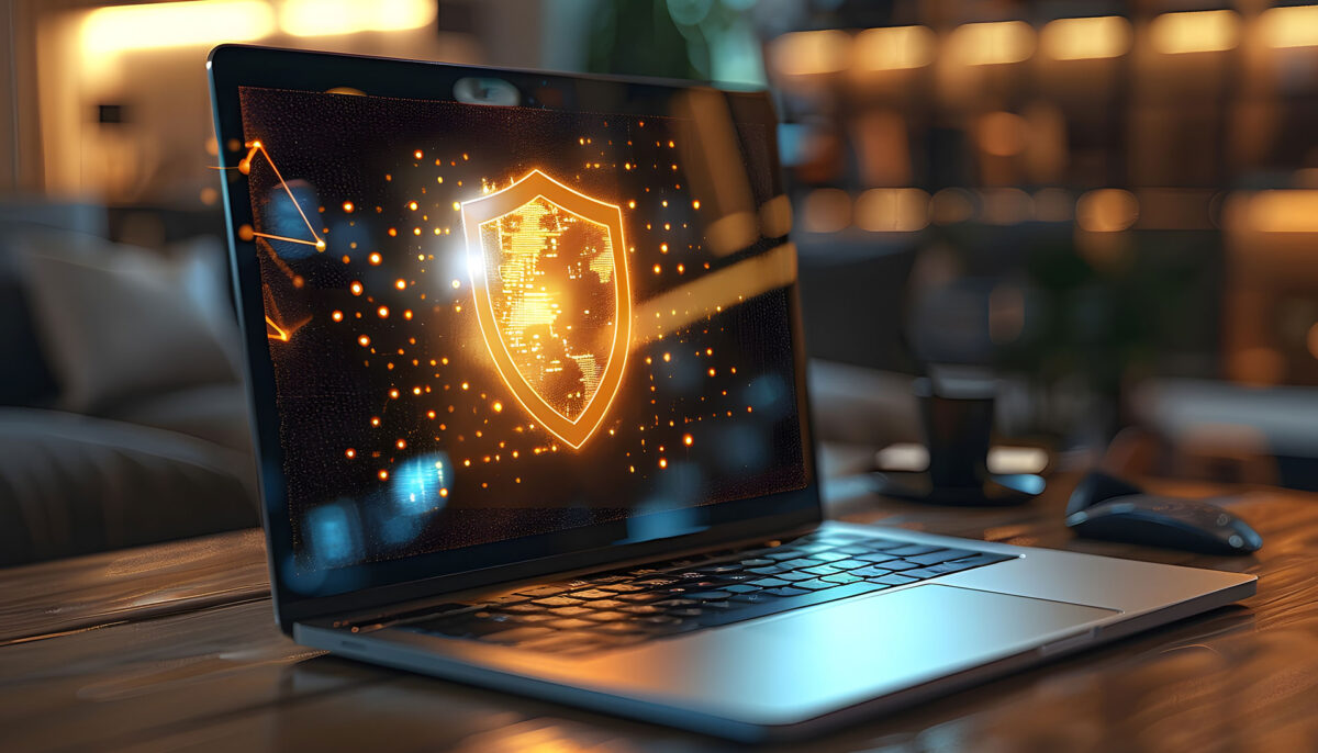 digital image of a shield on a laptop monitor sitting on a desk