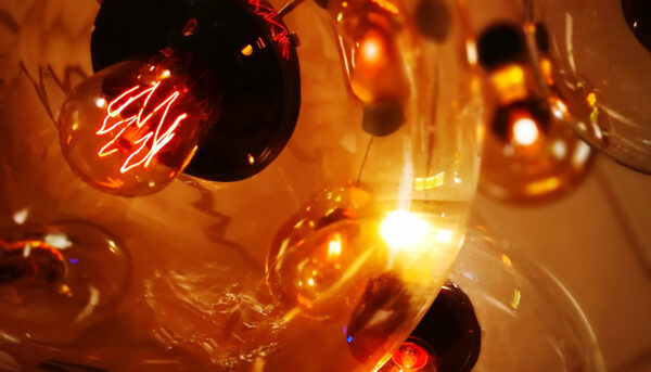 Low angle view of illuminated lighting equipment hanging from the ceiling